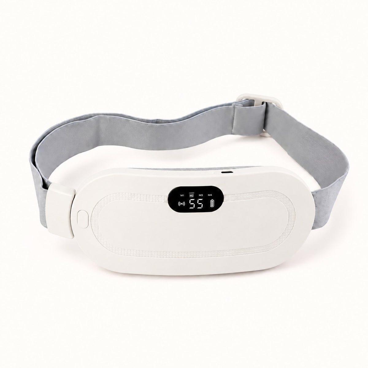 Ceinture chauffante CHALYNE blanche posée à plat, sangle grise déployée, écran de réglage allumé